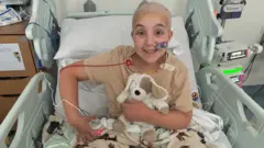 Lexi Johnson sat in hospital