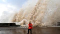 A woman takes a picture of a huge wave