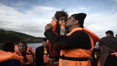 A man kisses a girls as refugees and migrants arrive on the Greek island of Lesbos in December 2015