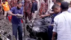 People clear debris at plane crash site