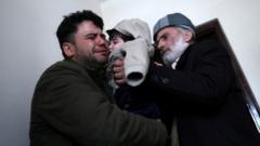 Hamid Safi, o taxista de 29 anos que encontrou o bebê no aeroporto, chora ao entregar Sohail ao avô