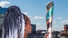 Artist, Laura Nyahuye, holds the Birmingham 2022 Commonwealth Games Queen’s Baton
