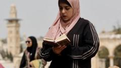 A Muslim woman reads from the Quran on the Haram al-Sharif/Temple Mount compound in Jerusalem's Old City (8 April 2022)