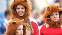 fans in lion costumes