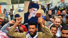 Supporter holds portrait of Moqtada al-Sadr, Najaf, Iraq (07/12/19)