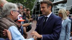 French President Emmanuel Macron greets supporters as he arrives to vote in the second round of French parliamentary elections, at a polling station in Le Touquet-Paris-Plage, France, June 19, 2022