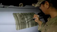 US Air Force/Reuters A soldier signs a bomb: