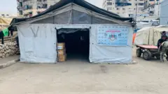 A tent in Gaza, with other tents visible in the background.