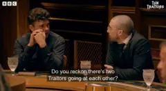 Harry and Zack next to each other at the roundtable with Harry asking Zack