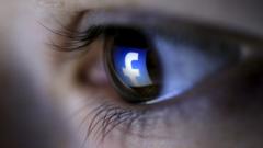 illustration shows a Facebook logo reflected in a person"s eye.