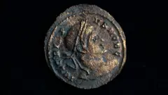 Tony Jolliffe BBC A close up of a Roman coin with detail found during HS2 archaeological excavations