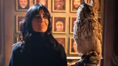 Claudia Winkleman in the Traitors castle with an owl