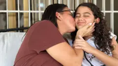 Karina (left) kisses her daughter Fabiana.