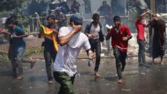 Protesters run for cover as police use tear gas to disperse them outside the Sri Lankan prime minister's office in Colombo, Sri Lanka