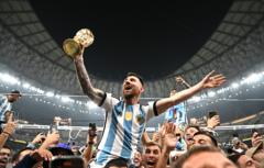 LUSAIL CITY, QATAR - DECEMBER 18: Lionel Messi of Argentina celebrates with the World Cup Trophy after winning the FIFA World Cup Qatar 2022 Final match between Argentina and France at Lusail Stadium on December 18, 2022 in Lusail City, Qatar