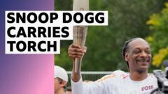 Rapper Snoop Dogg carries Olympic torch through Paris