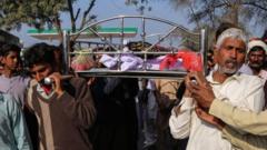 Relatives and locals carry a coffin containing the body of a man for his funeral at Khanewal district on Sunday 13 February 2022