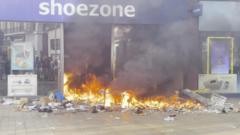 Cars and shop torched in violent UK protests