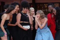 Reuters Taylor Swift with her crew at the premiere of the Eras tour movie in 2023