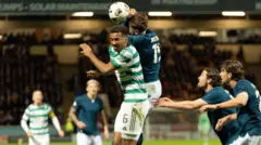 Motherwell's Sam Nicholson jumps with Celtic's Aaron Trusty