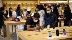 Customers visit the new Apple flagship store in Beijing, China, 17 July 2020. Apple opens its new flagship store in Beijing on 17 July, replacing its first store in China which opened in 2008