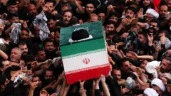 The coffin of Iran's late Supreme Leader Ayatollah Ali Khamenei is carried during a funeral procession at the Imam Ali shrine in Najaf, Iraq (8 July 2026)