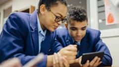 Pupils using a mobile phone in school