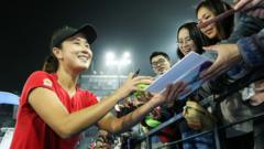 Chinese tennis player Peng Shuai signing autographs