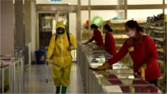 Employees spray disinfectant and wipe surfaces as part of preventative measures against the Covid-19 coronavirus at the Pyongyang Children's Department Store in Pyongyang on March 18, 2022.