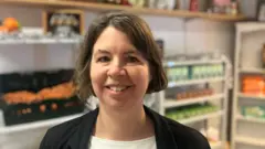 Photograph of Lynn Brandwood from the Stockport based charity Re:dish. She is pictured inside her shop in Reddish.