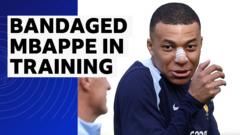 Mbappe trains with bandaging on broken nose