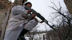 A militant of the self-proclaimed Luhansk People"s Republic holds a weapon at fighting positions on the line of separation from the Ukrainian armed forces in the village of Zholobok in Luhansk Region, Ukraine January 25, 2022