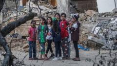 Palestinian girls play in rubble in Beit Hanoun, northern Gaza