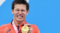 Tokyo 2020 Paralympic Games - Swimming - Men's 100m Butterfly - S11 Medal Ceremony - Tokyo Aquatics Centre, Tokyo, Japan - September 3, 2021. Gold Medalist Keiichi Kimura of Japan reacts on the podium REUTERS/Kim Kyung-Hoon