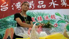 Chinese woman prepares a stand to display Taiwan-grown fruit displayed at the 4th China International Consumer Goods Fair on June 8, 2005 in Ningbo, Zhejiang province, China.