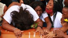 People cry during a funeral for five minors who were found dead in a sugar cane field, in Cali, Colombia August 14, 2020.