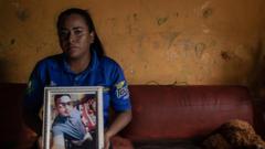 Vanesa Avila holds a picture of his death husband