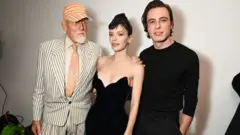 Getty Images Antony Price, Lily Allen and Marco Capaldo pose backstage at the 16Arlington x Antony Price Salon Show on November 17, 2025 in London, England.