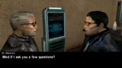 Eidos A screenshot from the video game Deus Ex. Two men in the game are staring at each other, in front of a machine with the words