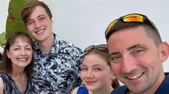 Nicola Burrows Family photo of Nicola, her children and husband. They are all smiling at the camera