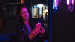 Woman checks phone at a club