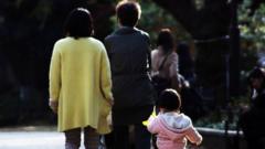 This picture taken on December 12, 2015 shows a family strolling at a park in Tokyo.
