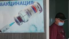 A man walks past a poster for a Russian coronavirus vaccine