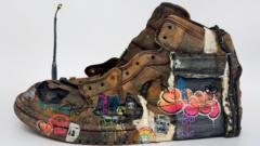 The shoe design created by Stella Stockbridge which shows graffiti painted onto a trainer