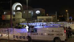 Israeli emergency service personnel close-off the site of a reported attack at a synagogue