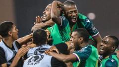 Comoros' forward Ahmed Mogni (C) celebrates with teammates after scoring his team's second goal during the Group C Africa Cup of Nations