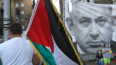 Demonstrator carries a Palestinian flag at a protest in Tel Aviv against Israel's annexation plans (06/06/20)
