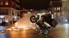 A man dey ontop bike as unrest dey hapun for The Hague