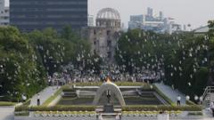 In this August 6, 2013 file photo, doves fly over the cenotaph dedicated to the victims of the atomic bombing at the Hiroshima Peace Memorial Park during a ceremony marking the 68th anniversary of the bombing, in Hiroshima, western Japan.