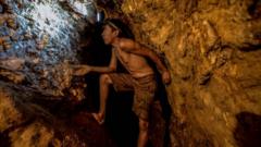 El Callao'daki La Culebra altında madeninde 1 Mart 2017'de çekilen bu fotoğrafta bir çocuk altın madeni arıyor.